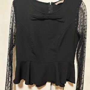 Darling black peplum top with polka dot mesh sleeves